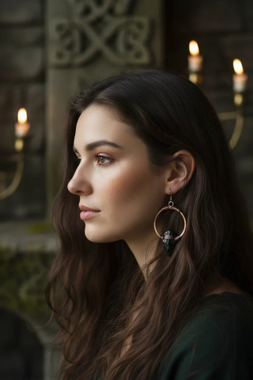 Black obsidian arrowhead earrings on copper hoops - Model wearing for scale