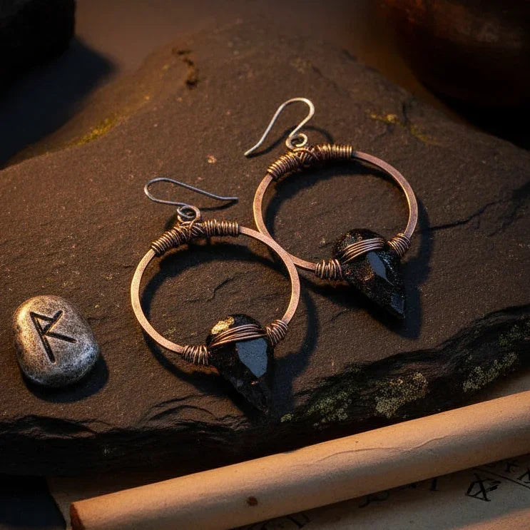 Black obsidian arrowhead earrings on copper hoops with ancient mysterious styling